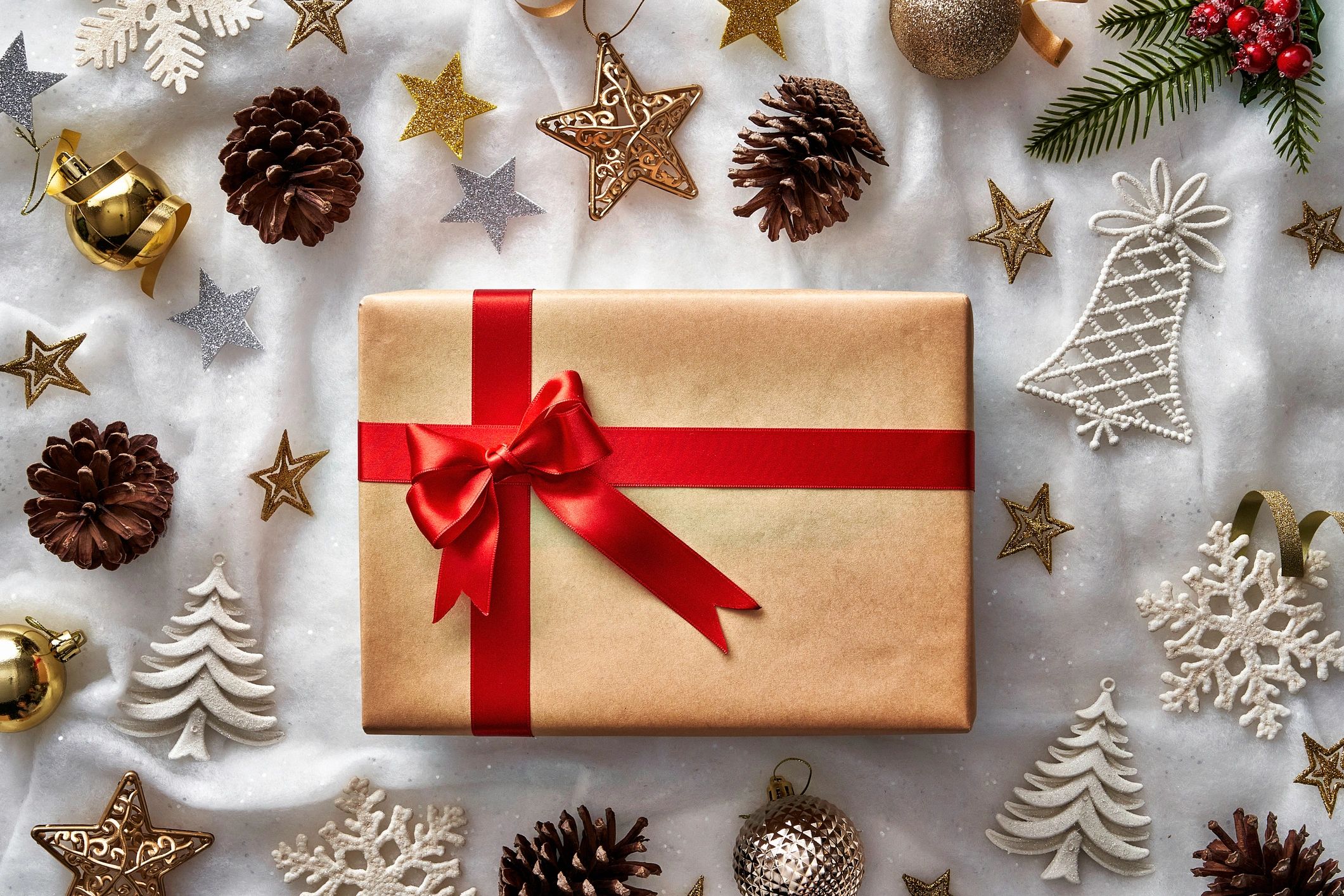 Top view of Christmas present and ornament elements on white background