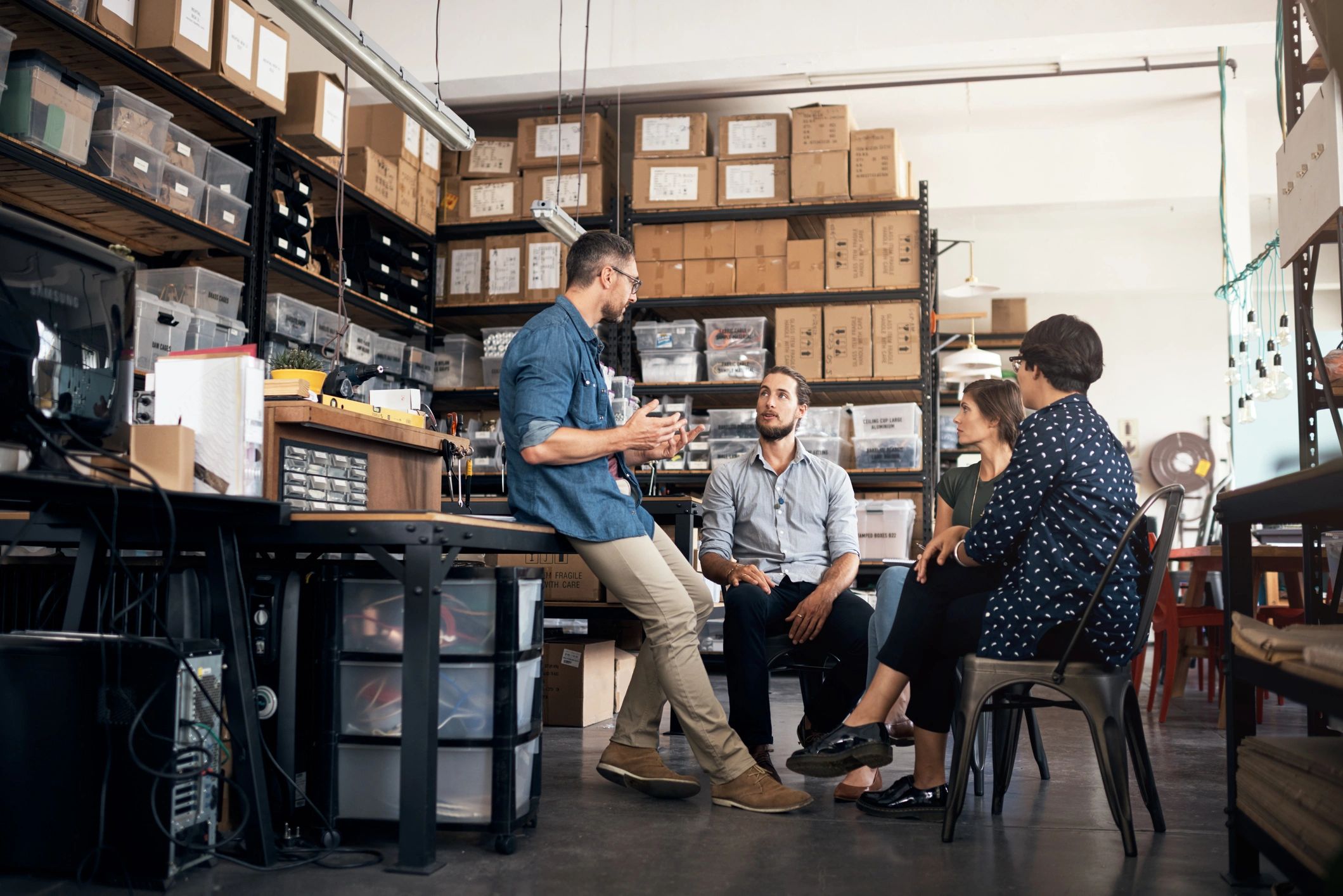 Small business team discussing production plans in a workshop
